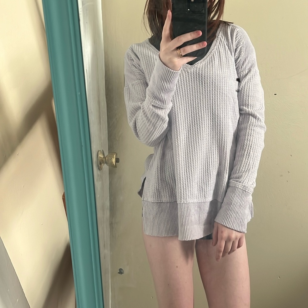 long sleeved, light purple sweater